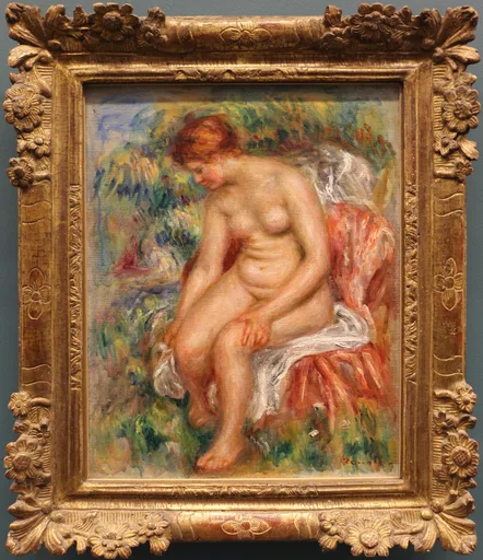 A seated nude bather drying her leg amid greenery, in warm flesh tones, coral, and soft green, in an ornate gold frame