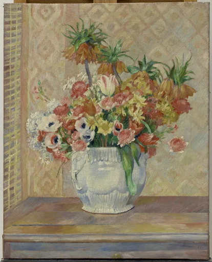 A still life of mixed anemones, daisies, and crown imperial lilies in a white ceramic pitcher on a wooden table, in coral, yellow, and cream