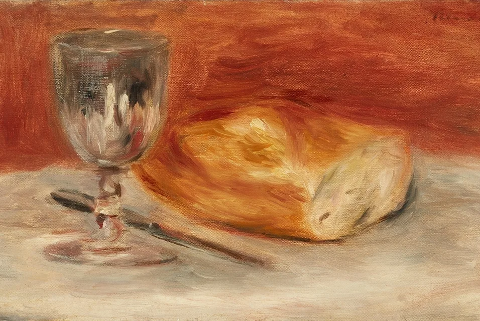 A wine glass and a knife beside a half loaf of bread on a table, in warm red, gold, and cream