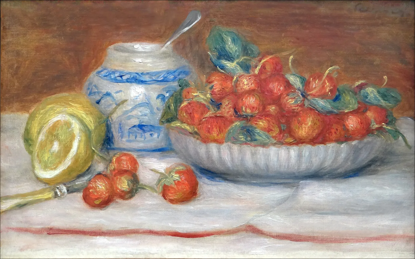 A bowl heaped with strawberries sits beside a blue and white ceramic pot and a halved melon on a white tablecloth, in vivid red, blue and cream