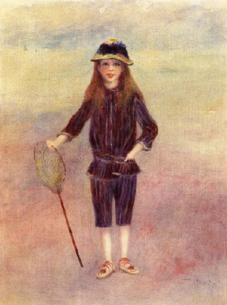 A girl in a navy striped outfit and straw hat stands holding a fishing net on a pale sandy beach.