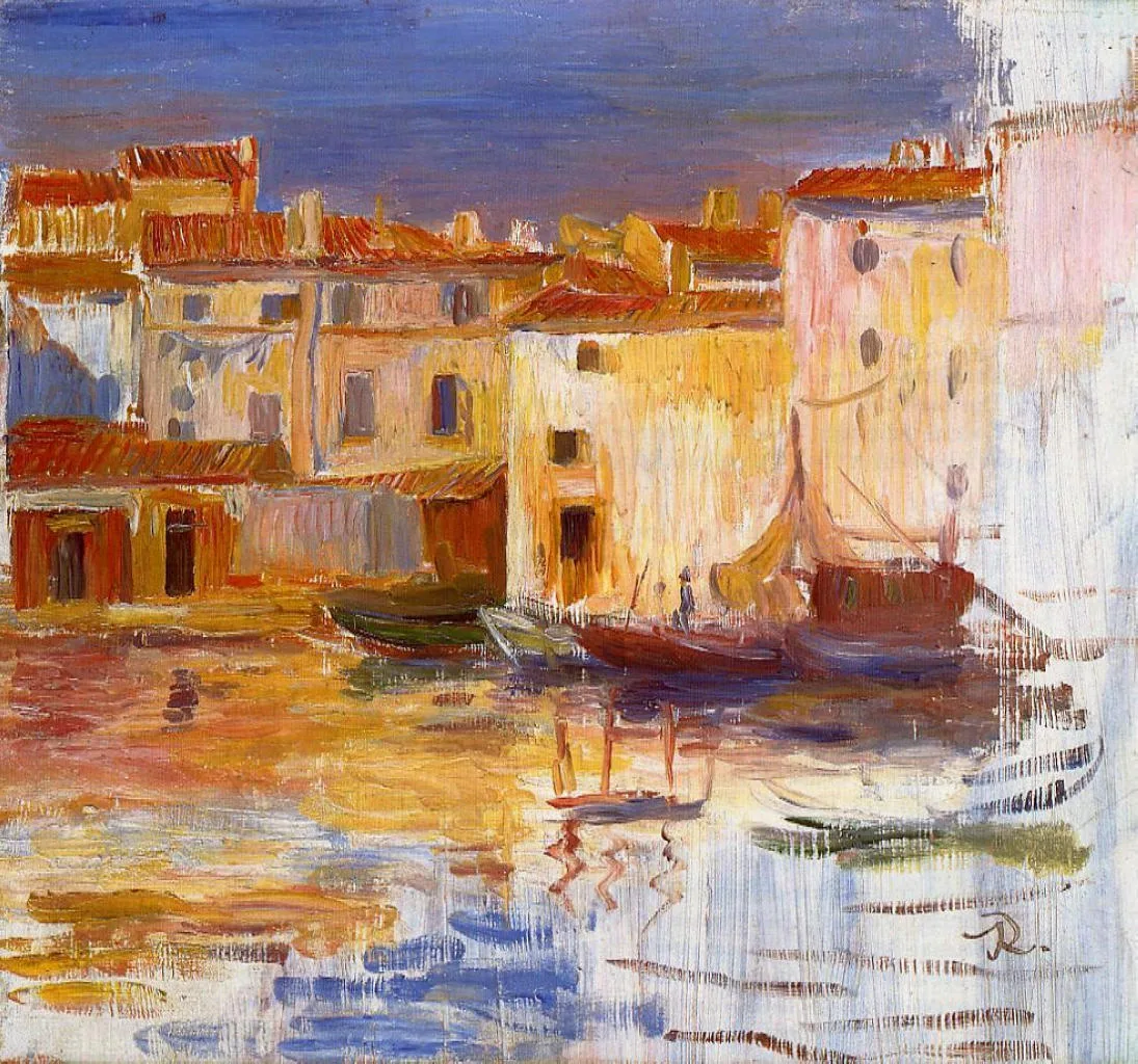 A harbour of terracotta-roofed buildings and moored fishing boats glows with warm reflections under a blue sky.