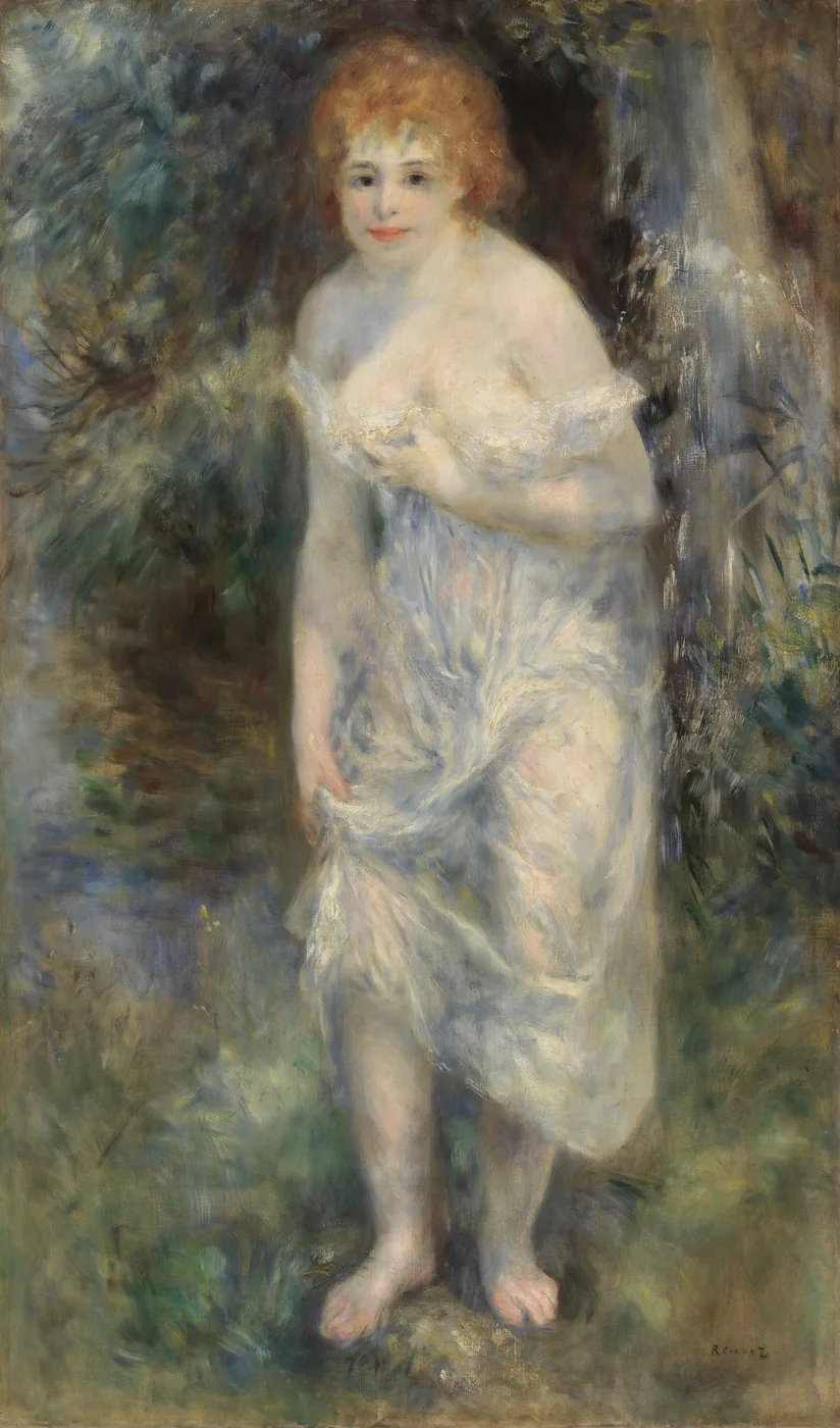 A red-haired woman stands barefoot in a wood, a pale blue-white drape slipping off her shoulders, amid green and brown foliage