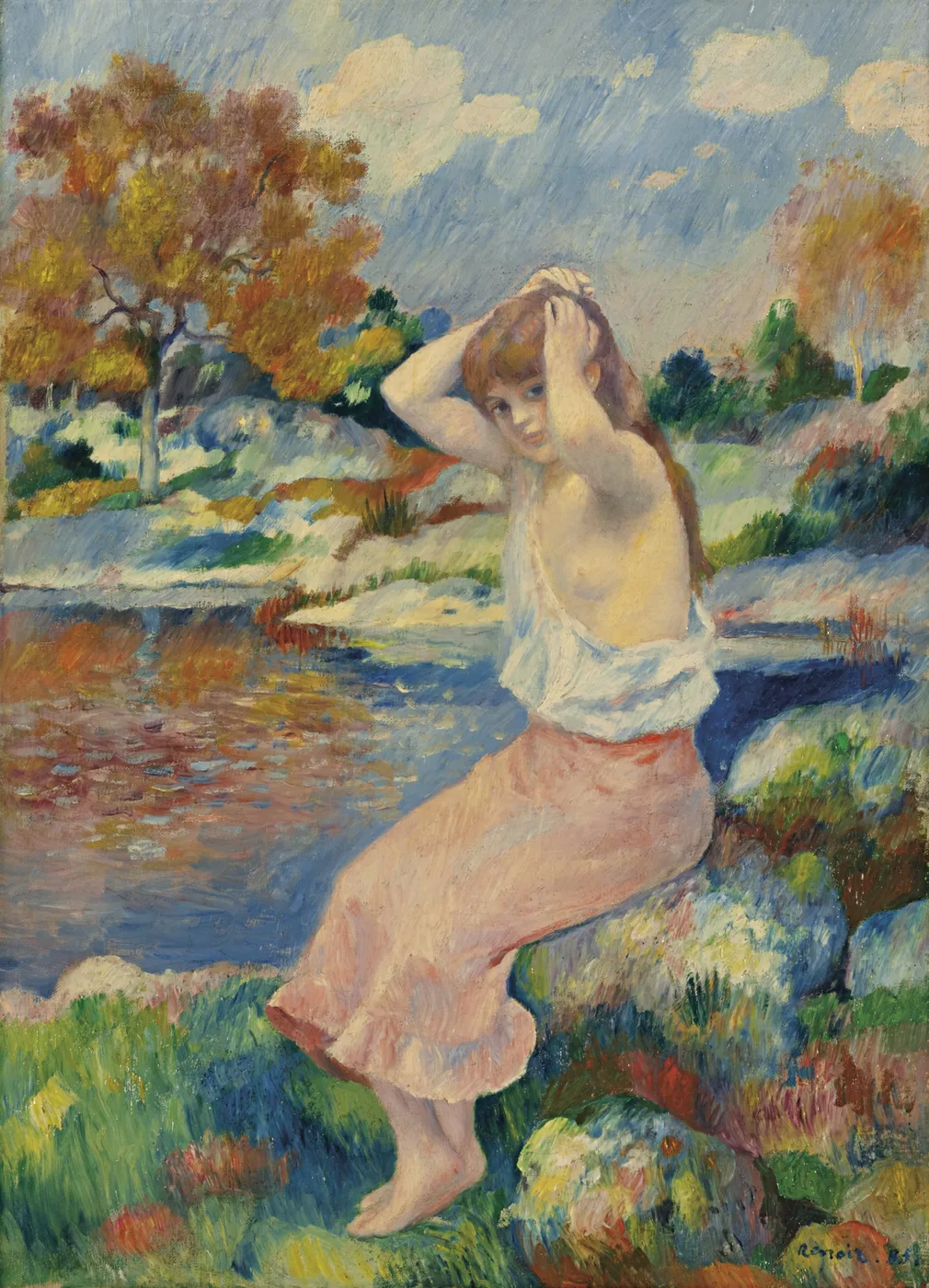 A young woman by a riverbank pulls her white blouse from her shoulders, pink skirt below, amid colourful autumn trees.