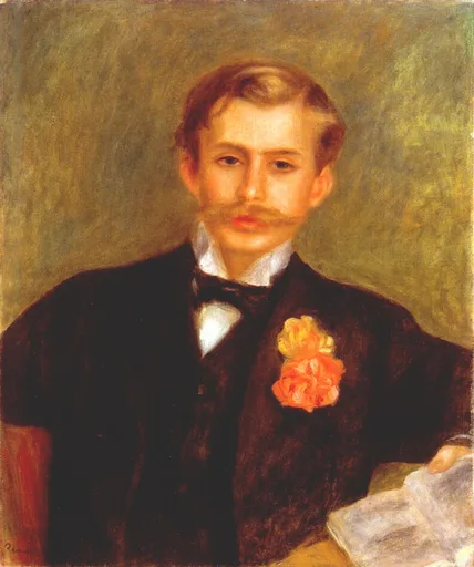 A mustached young man in a black suit and bow tie wears an orange carnation, against an olive-green background.