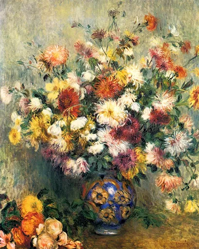 An abundant bouquet of shaggy chrysanthemums in red, yellow, and white fills a blue-and-gold patterned vase, with loose blooms piled beside it on the table.