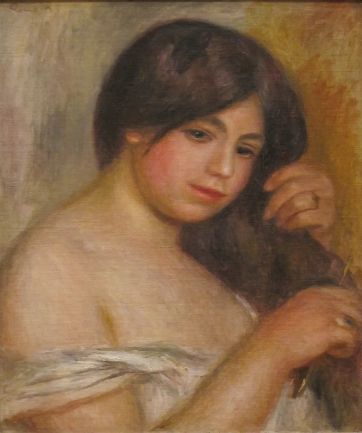 A bare-shouldered young woman with loose dark hair combing it back with one hand, in warm flesh, brown, and golden ochre tones