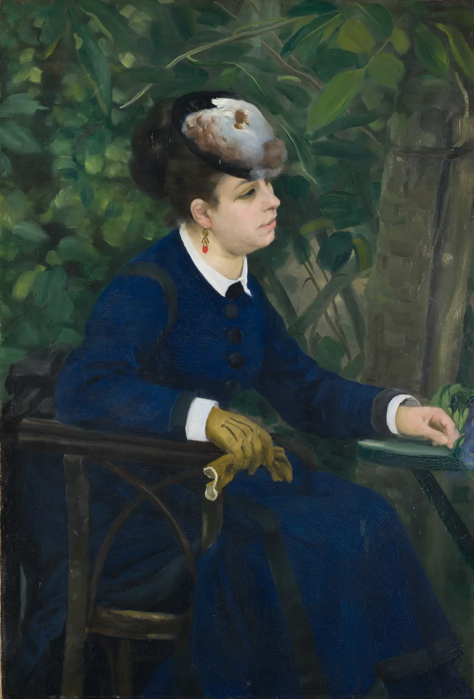 A woman in a navy blue dress and feathered hat seated in a garden chair, wearing yellow gloves, against dense green