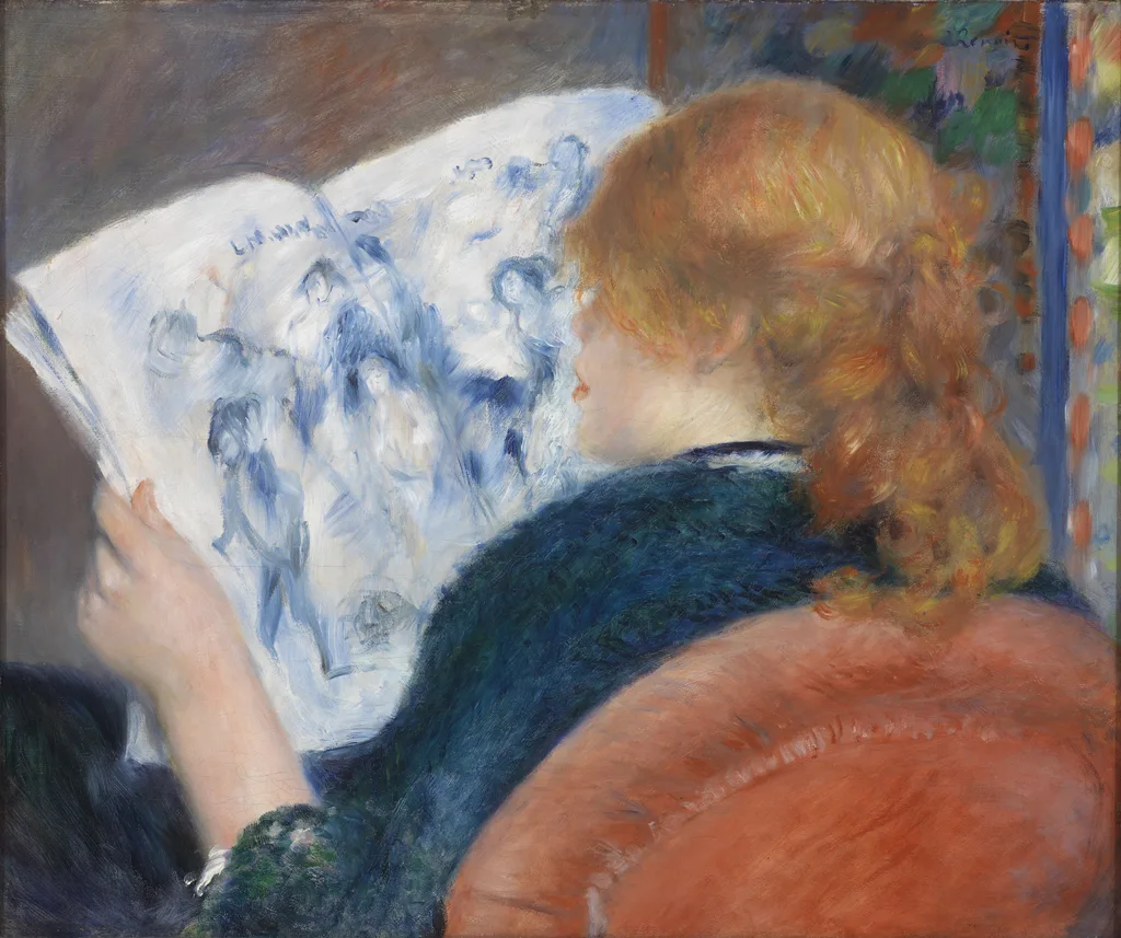 Seen from behind, a red-haired woman in a dark green shawl leans over an open illustrated journal on an orange armchair